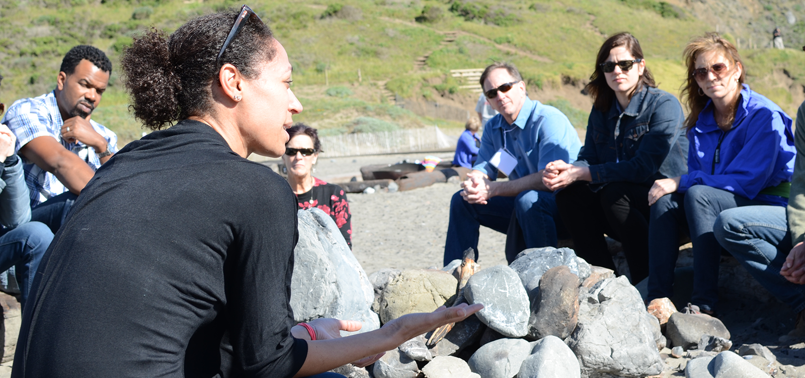 Group talking on beach.